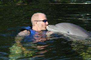 Ellis swimming with dolphins